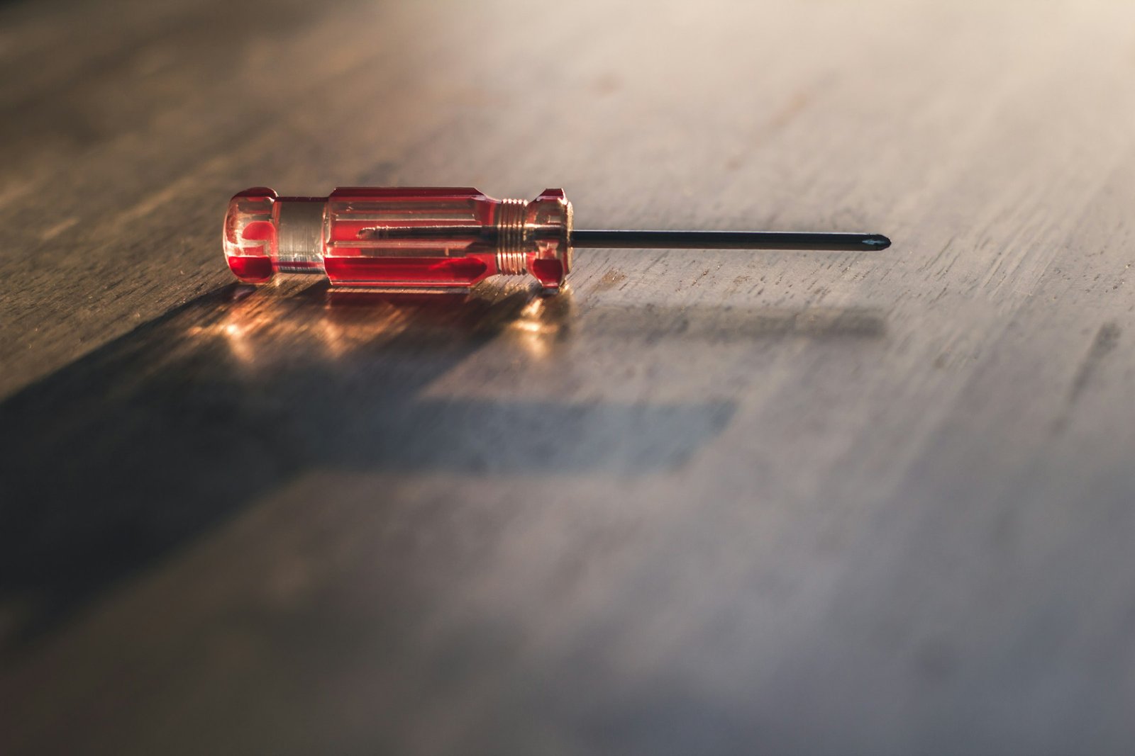 A technician's screwdriver on a workbench